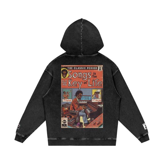Black hoodie with a graphic design on the back featuring a person playing piano.