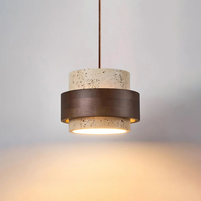 TerraHalo pendant lit, hanging from ceiling showing travertine and walnut wood two-tier shade