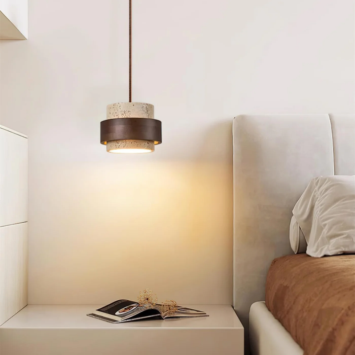 lifestyle bedside scene with pendant lit beside upholstered headboard