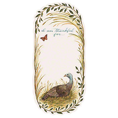 a notepad with cursive writing reading "I am thankful for..." with a turkey