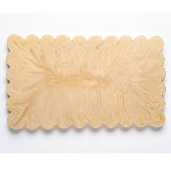 A rectangular wooden serving board with a wavy scalloped edge, featuring a natural light tan wood grain pattern, shown on a plain white background.