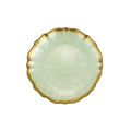 Light green plate with ruffled gold rim on a white background