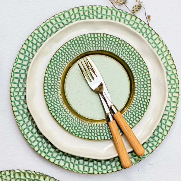 Set of green and white ceramic plates with a fork