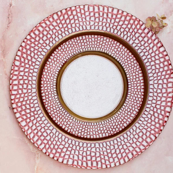 Decorative plate with red geometric pattern on a pink background
