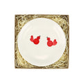 White plate with two red birds painted on it