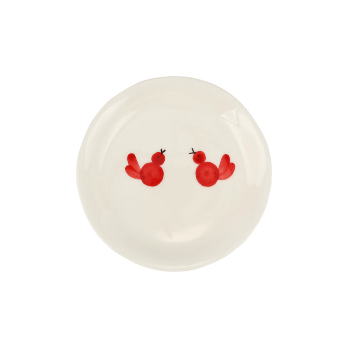White plate with two red birds painted on it