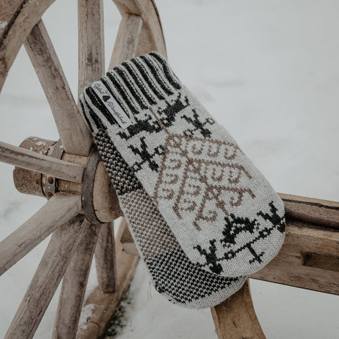 Wooden fixture with gray wool mittens resting on top.